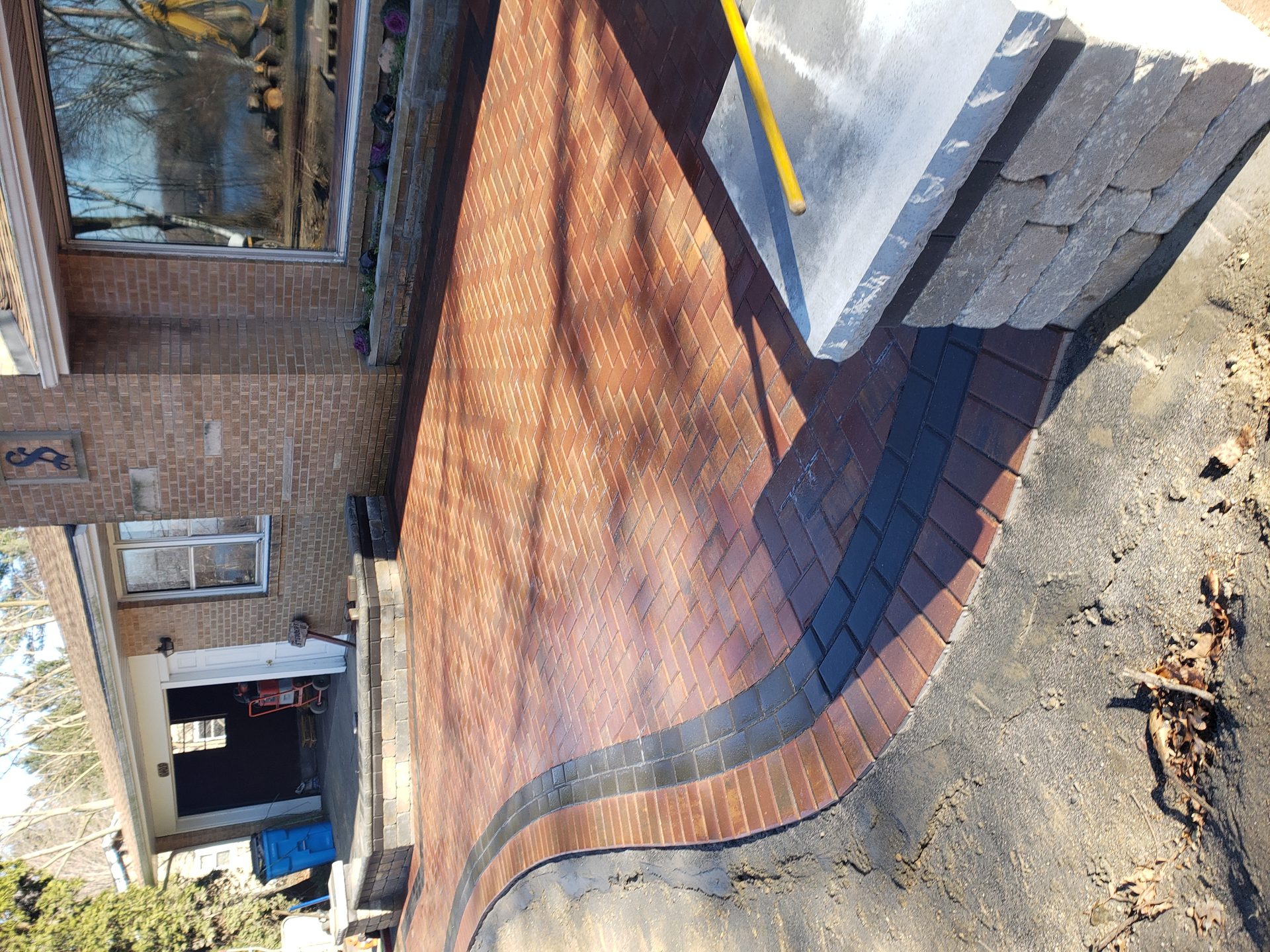 Curved red brick paver driveway and walkway