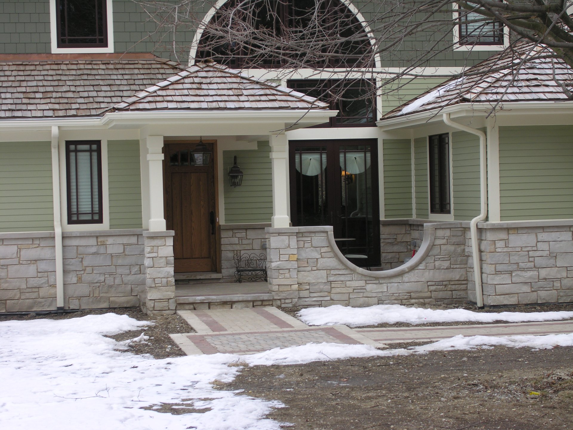 Entry porch with stone base and cedar shakes on a Zeiler Construction custom home