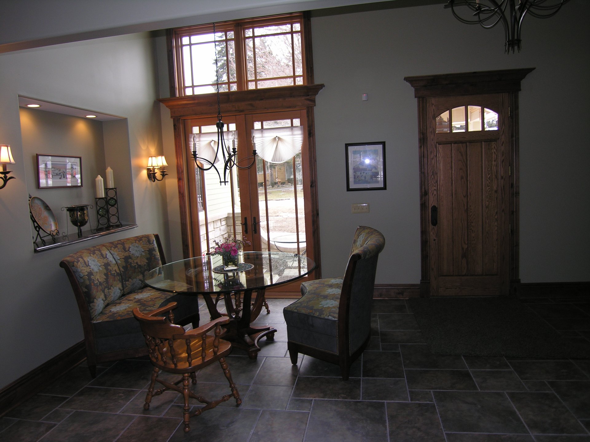 Foyer with custom trim, wood front door, and slate tile floor