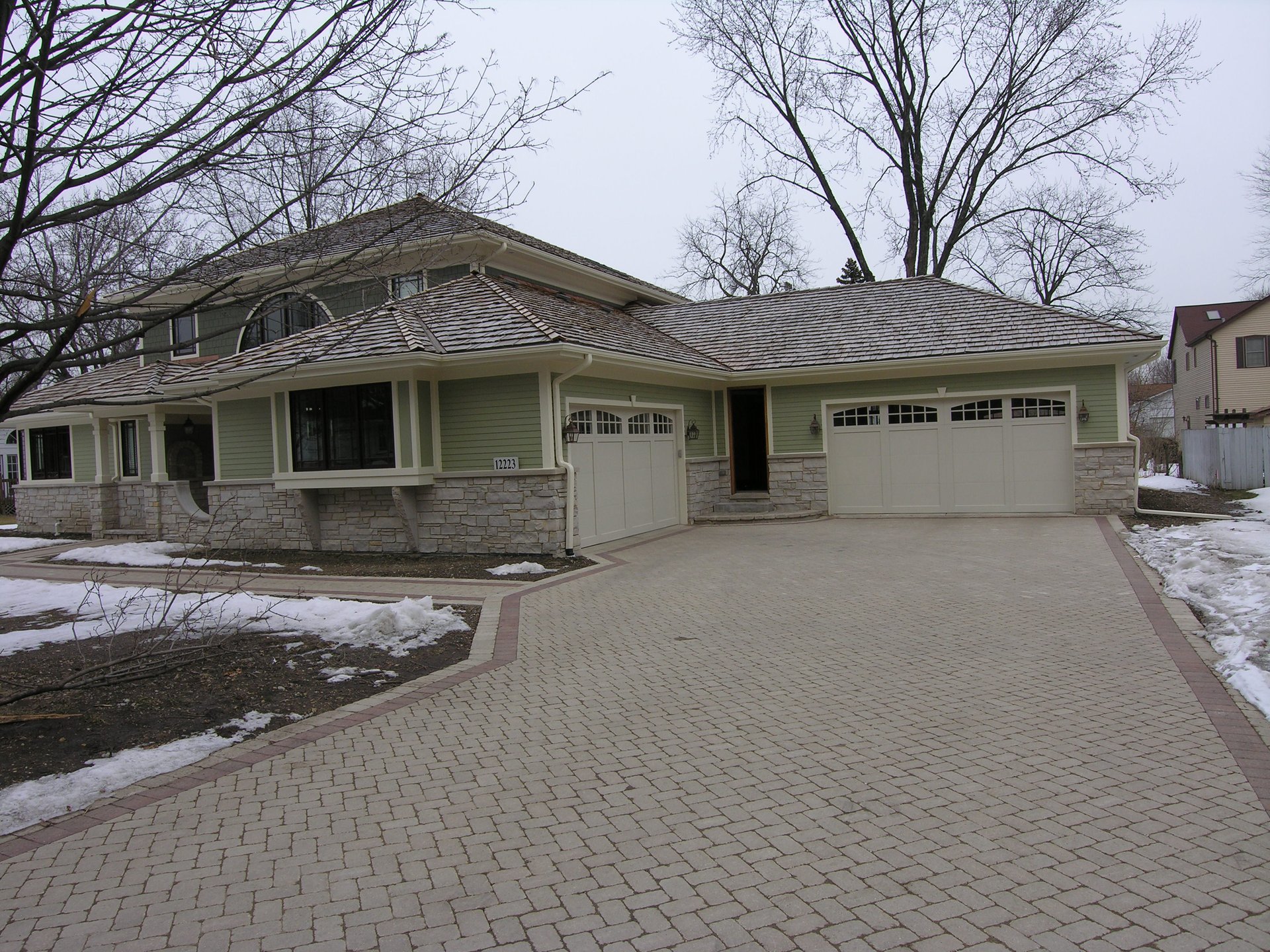Custom home built by Zeiler Construction in Palos Heights, IL with paver driveway