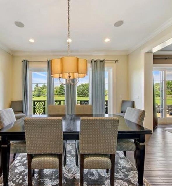 Dining room with curved staircase visible in the background