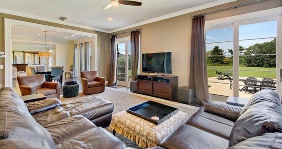 Family room with leather sofas and view to the paver patio