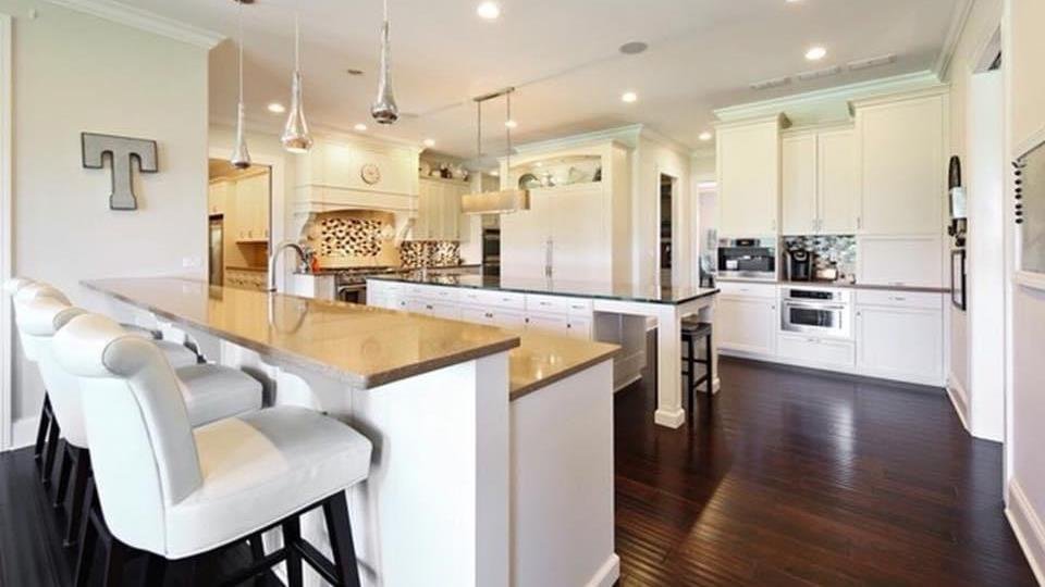 Custom white kitchen with double island and quartz counters