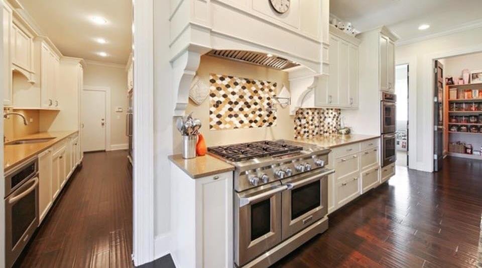 Custom kitchen with Wolf range and mosaic backsplash